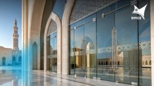 Frameless glass entrance doors and structural glazing for modern grand mosque facade.